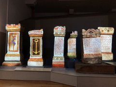 Roman alters with colourful animations projected onto their surface