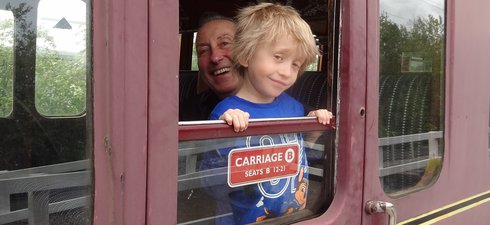 Man and boy at train carriage window