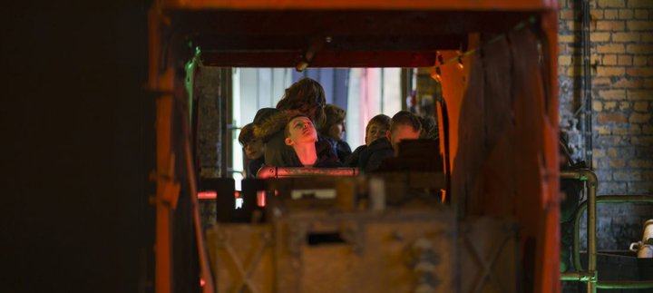 A group of school children explore a colliery building at Woodhorn Museum