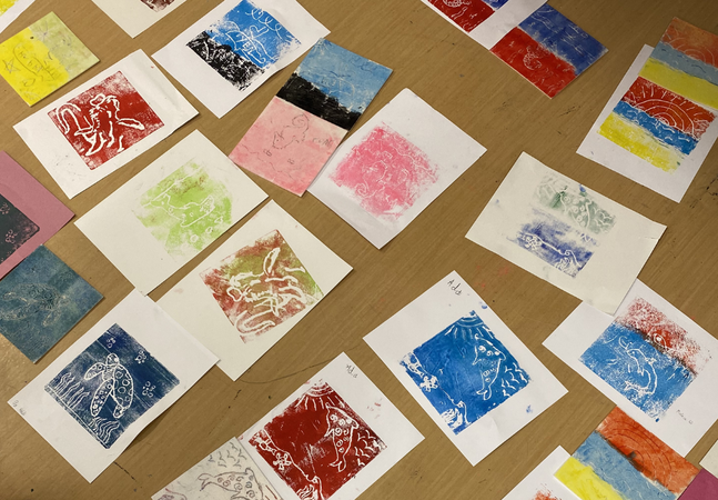 A photograph of a variety of prints made by children in fun, bright colours.