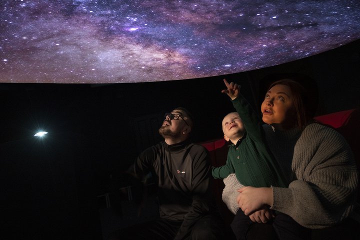 A family in a planetarium