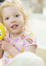 A young girl with a magnifying glass