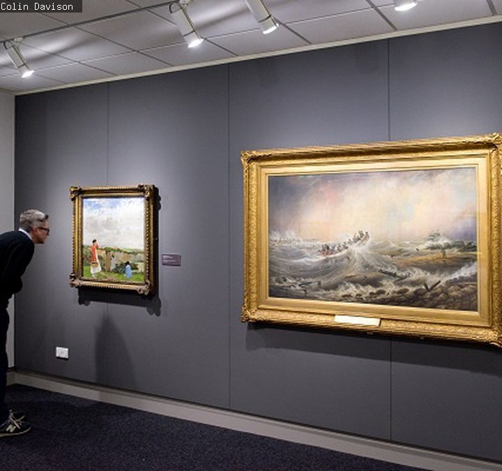 Man looks at a picture in the gallery