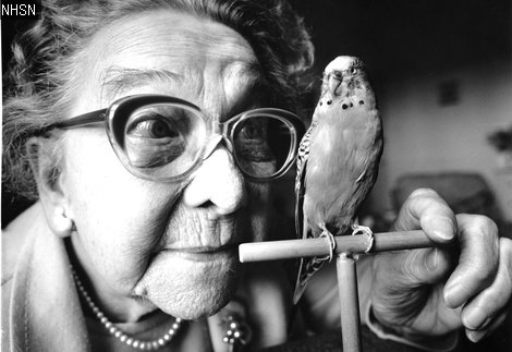 Black and white phot a lady and a budgie 