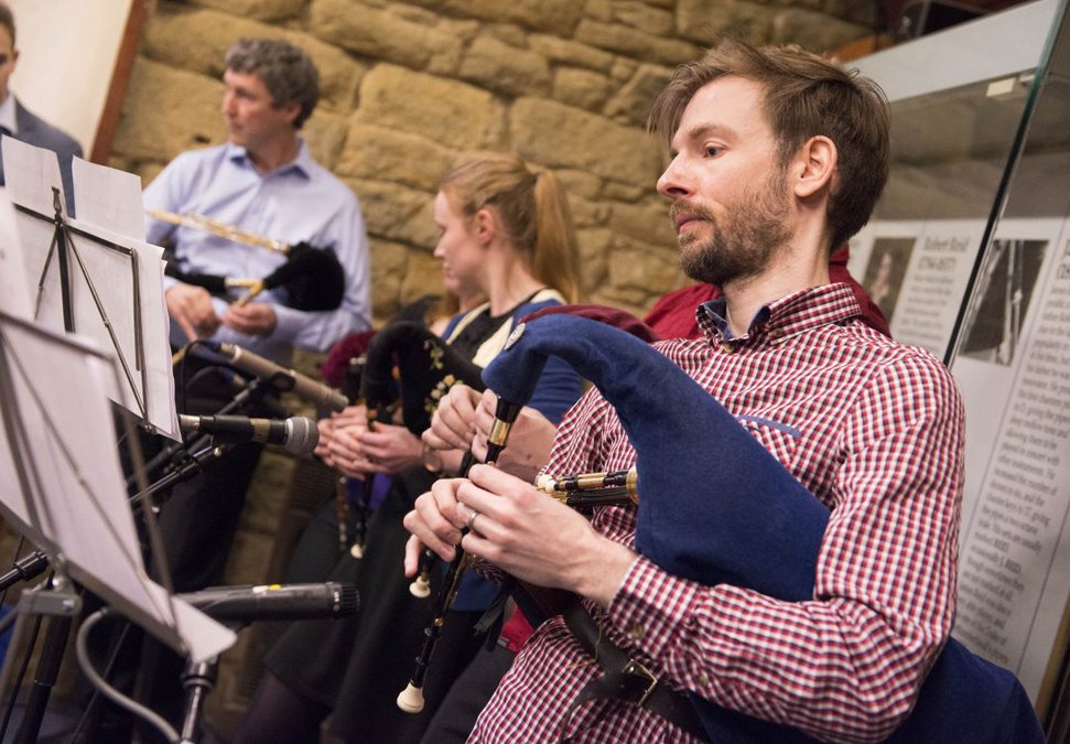 A group of musicians holding bagpipes 