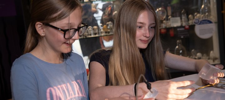 Two girls look at connections in the gallery