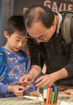 Dad and two children engrossed in craft