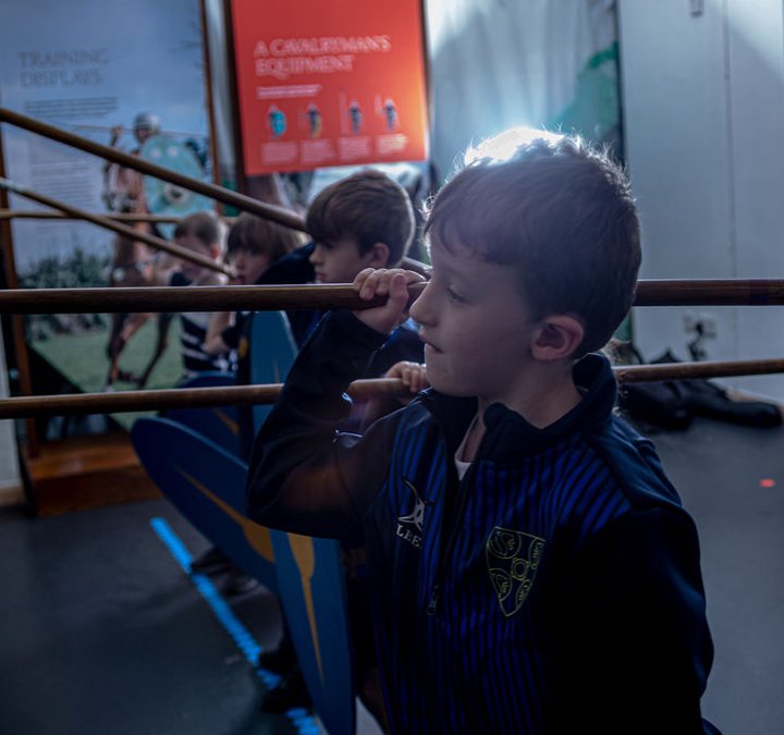 School boys holding spears ready to launch an imagined attack