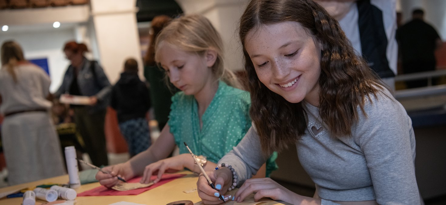 Two girls in Roman Gallery taking part in a writing activity expirers 