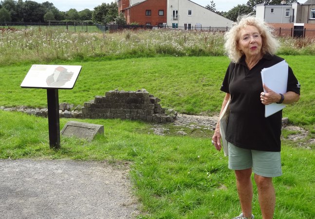 Woman standing near an information board