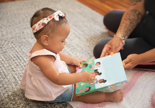  A baby holding a book