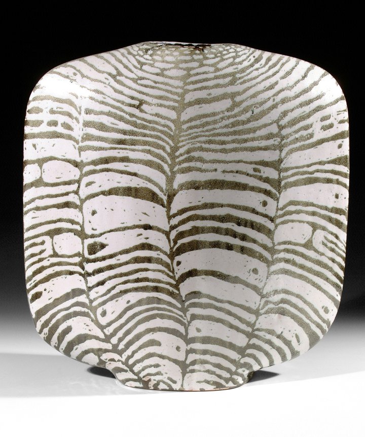 A black and white striped ceramic vessel