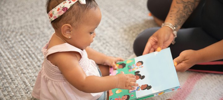  A baby holding a book