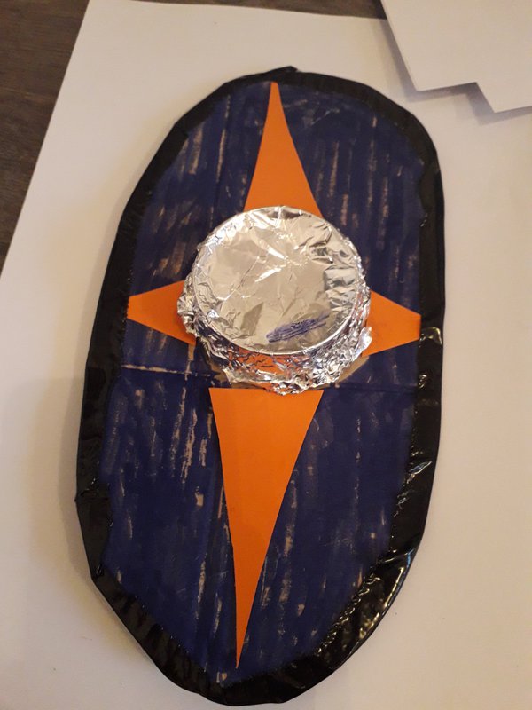 Shield decorated with silver boss and orange pattern