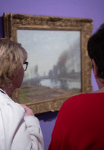 Two people viewing the Monet artwork