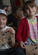 Children holding up their proggy crafts 