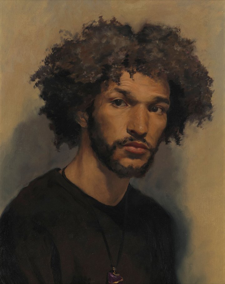 A portrait of a young man against a brown backdrop.