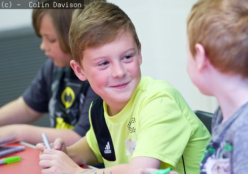 Two boys talking at an art academy day