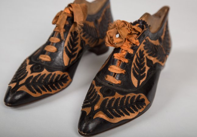 1800s black and orange lace up shoes.