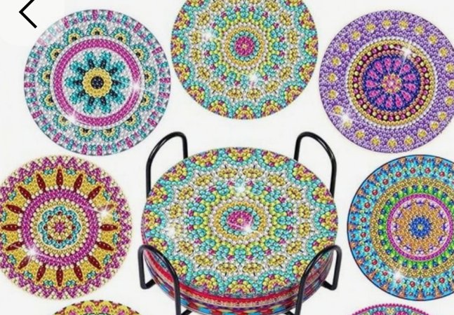 A set of decorated coasters in multi coloured gemstones.
