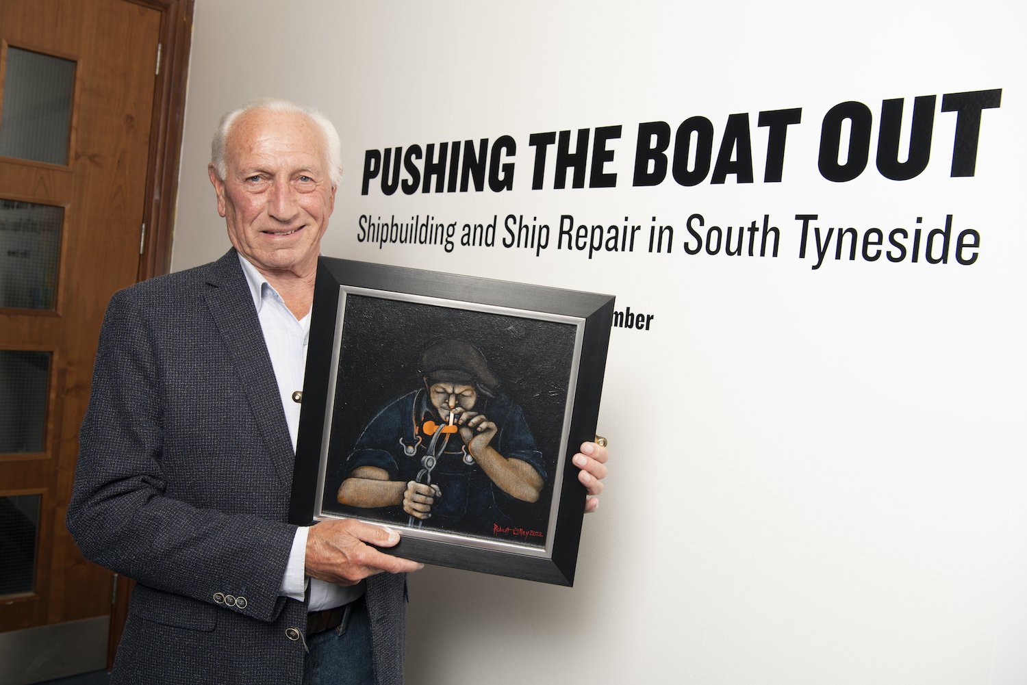 Robert (Bob) Olley holding his painting entitled ‘Fag Break’