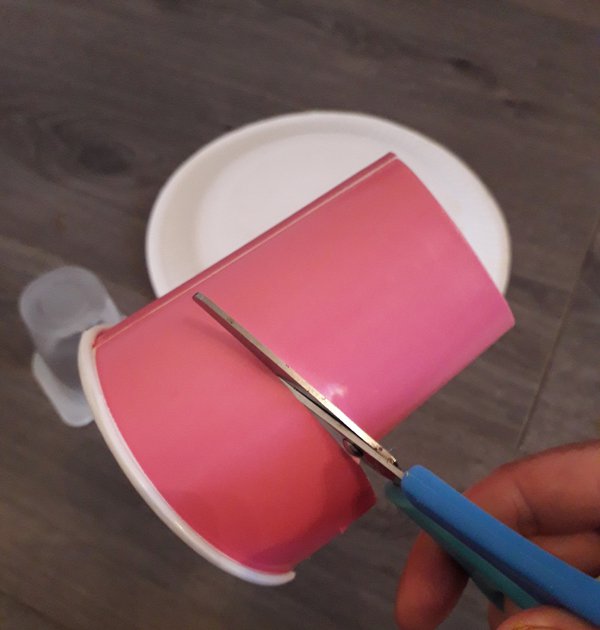 Scissors cutting paper cup