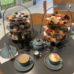 A photograph of three tiered afternoon tea with drinks