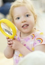 A young girl with a magnifying glass