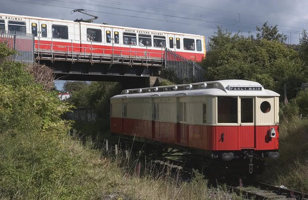 Original 1904 NER Tyneside Electric carriage No 3267 in the foreground with Tyne & Wear Metrocar 4027 painted in commemorative NER livery in the background. NER No 3267 is the only surviving Tyneside Electric vehicle and today you can see it on display at Stephenson Steam Railway. (TWCMS: R6)