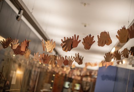 Paper hand with messages of support hang in the World Cultures Gallery