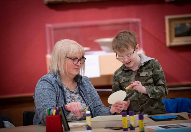 A photograph of a mum and child doing crafts together.