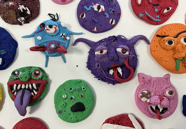 Different shaped, colourful monsters made out of clay.