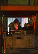 A group of school children explore a colliery building at Woodhorn Museum