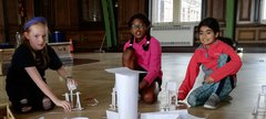 children in the Great hall do experiments 