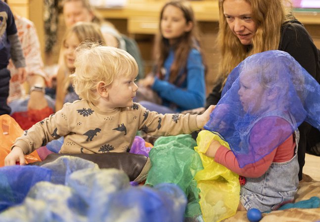 Toddlers at a play station with tactile items
