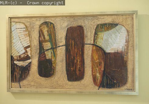 An abstract painting in earth colours on display. 