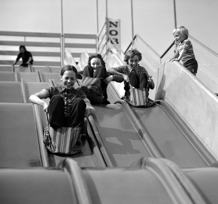 Archive photograph of people on slides at a funfair