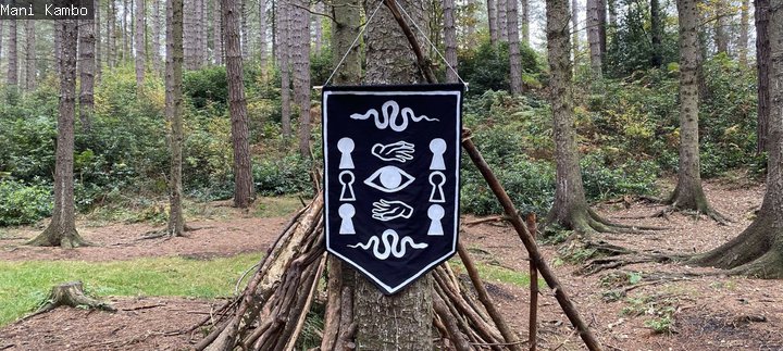 A banner with symbols hangs from a tree