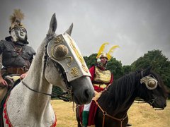 Two men dressed as Roman soldiers on horseback