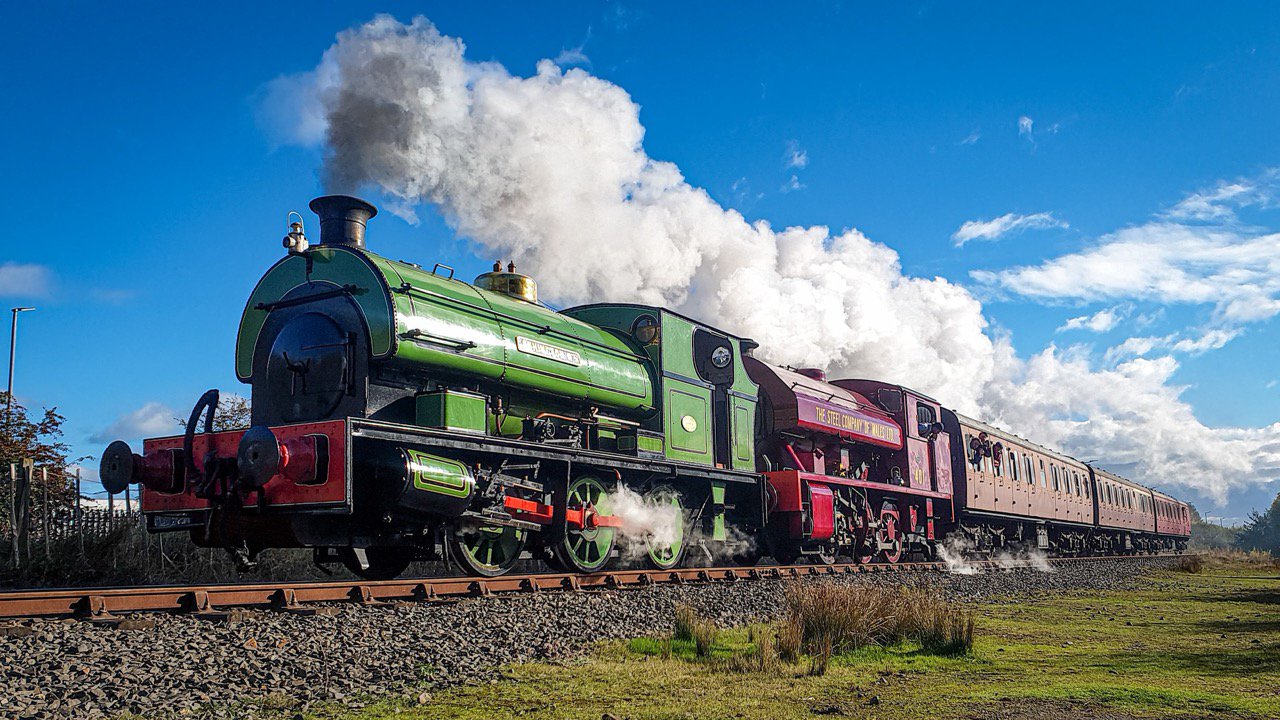 A train being hauled by two steam locomotives.