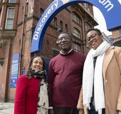 Exchange steering group - three smiling people outside Discovery Museum; they are Black, two women one man