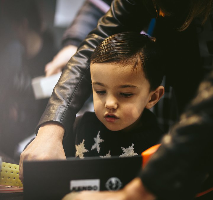 small boy creating with cardboard