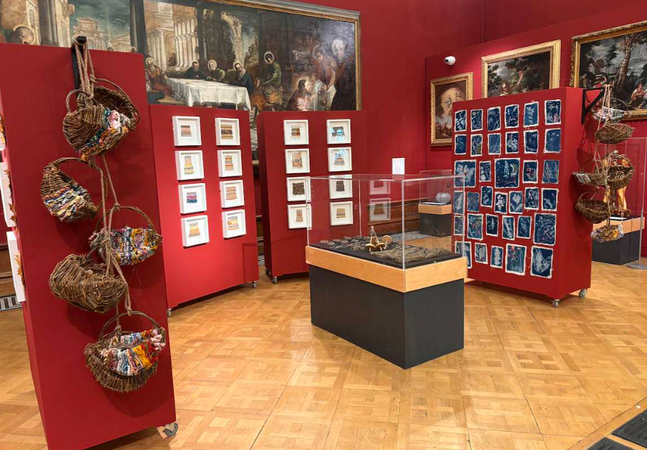 An exhibition of fabric objects in a gallery space.