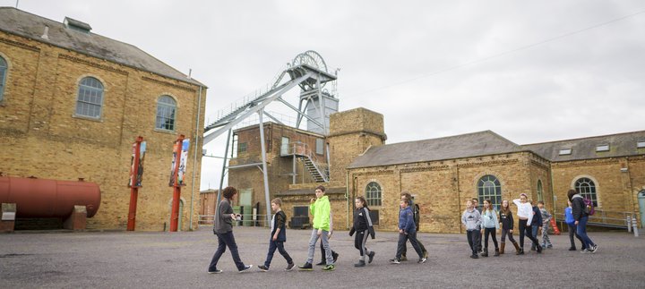 School children walking in a line in the outside of Woodhorn