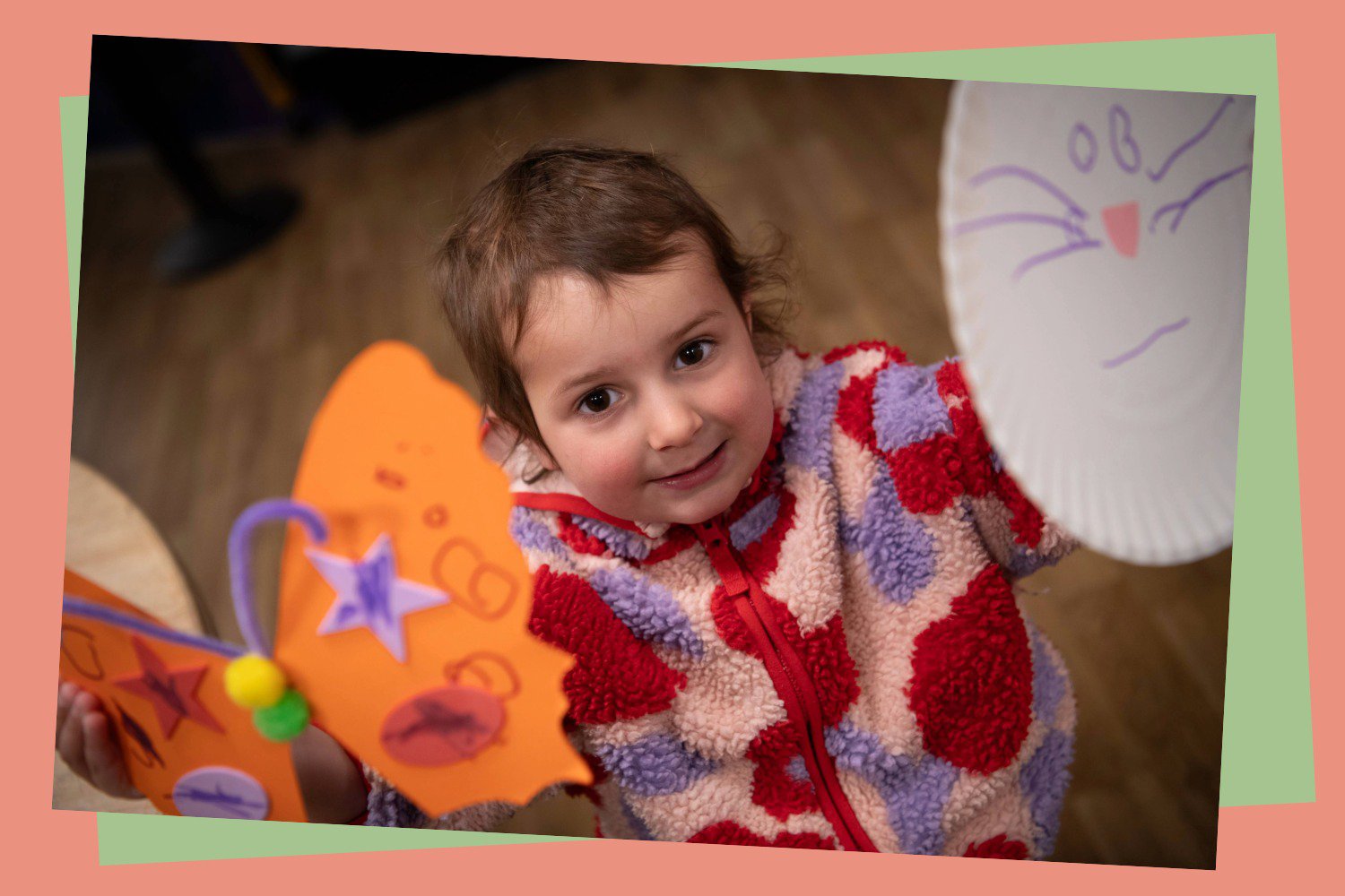 Child with paper plate crafts she has made.