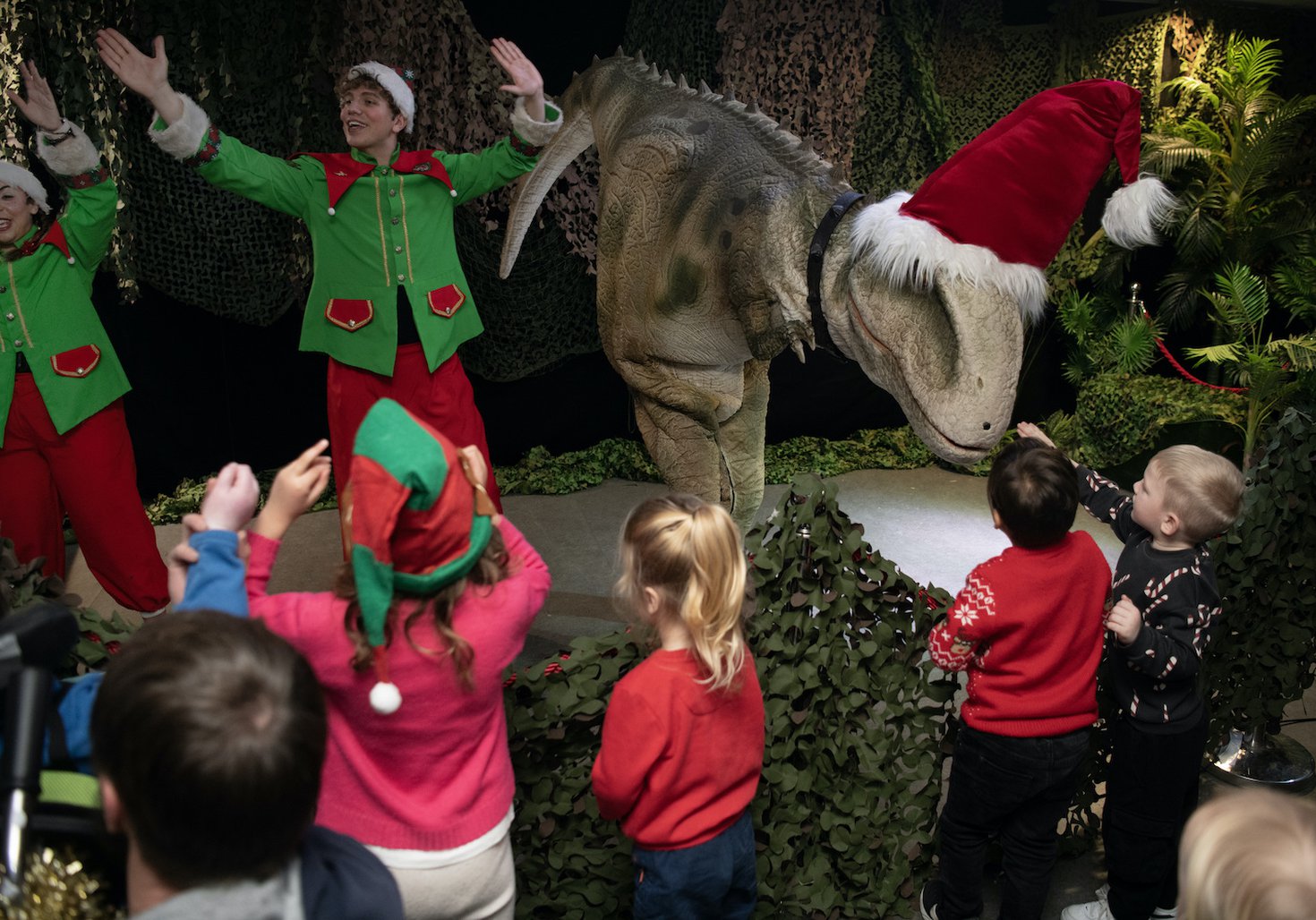 Festive dino show - kids, elves and a t-rex costumed peformer