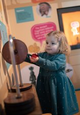 Toddler playing with interactive display in museum