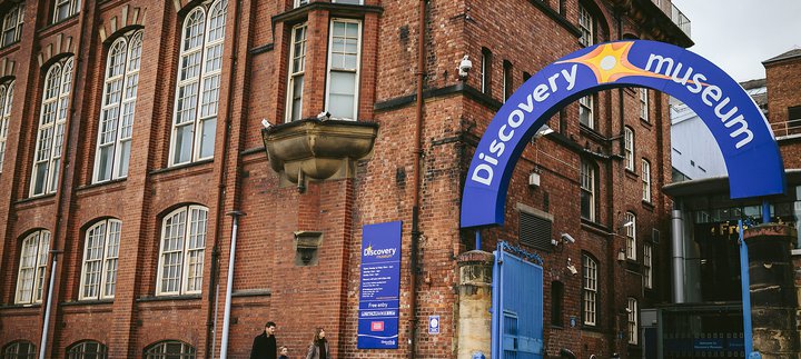A family enter Discovery Museum