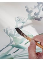 A hand painting a watercolour picture.