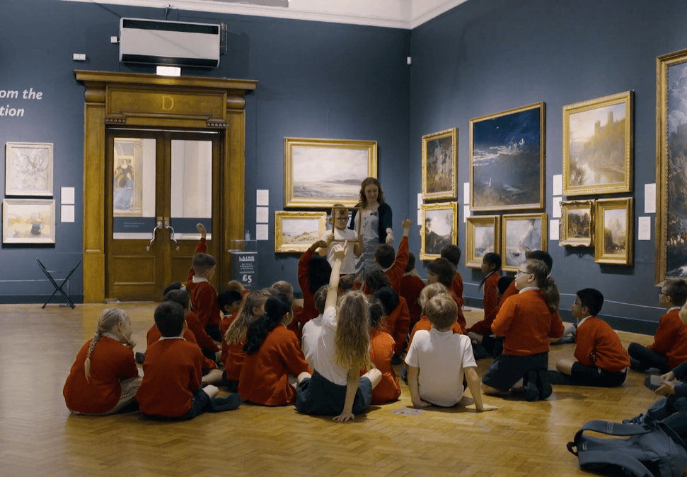 school children sitting down in the gallery 